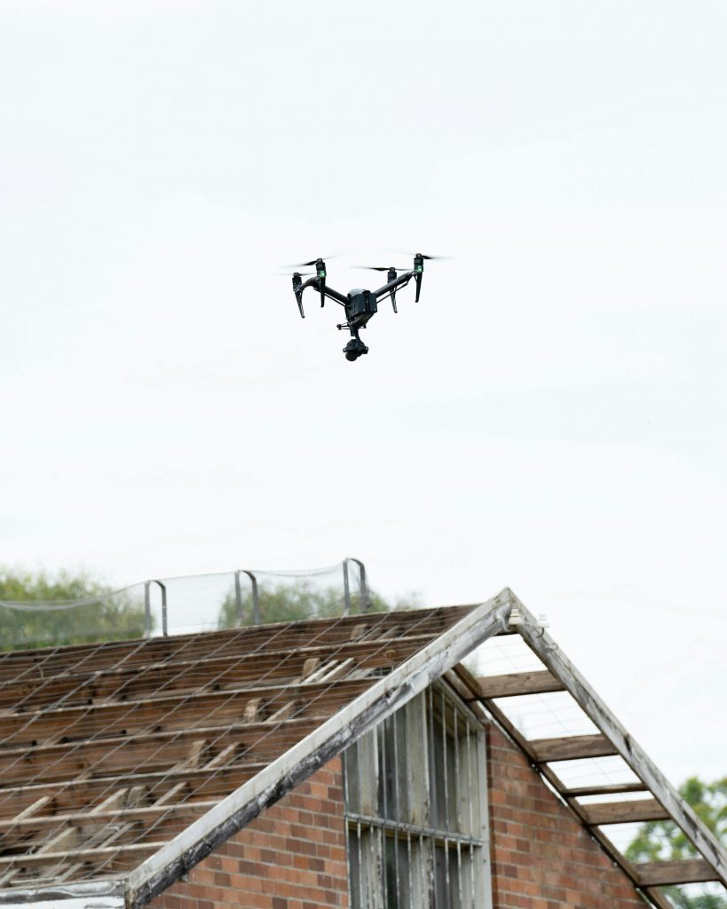pexels-photo-11748111-11748111 Aerial drone flying over a weathered rooftop in Sydney, capturing unique architectural views.